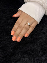 Close-up of Estelle coral almond press on nails