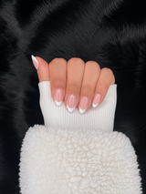 Romane french tip almond press on nails hand pose – Nailora Paris