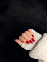 Scarlett long almond cherry red press-on nails — side view on black