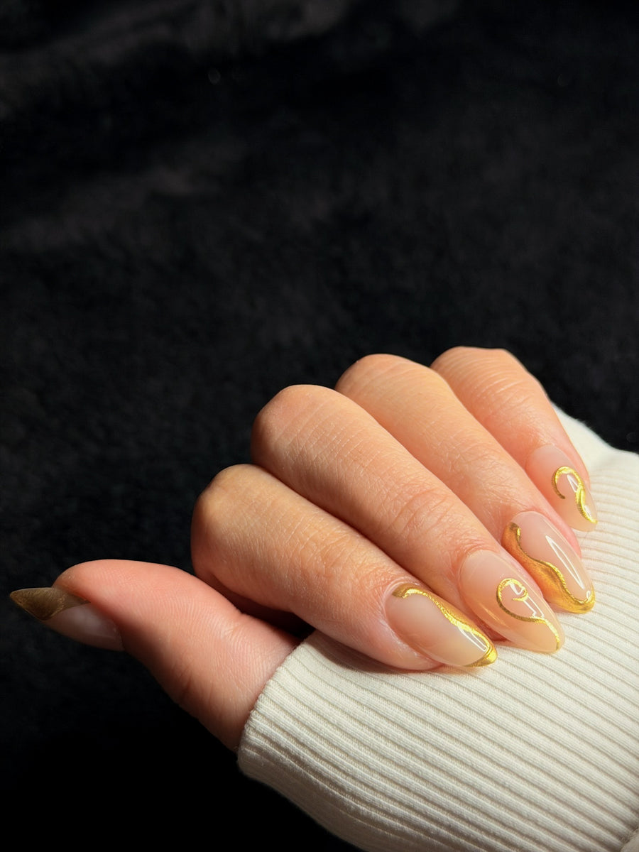 Nailora Paris — Octavie — Medium Almond Nude Gold Swirls press-on nails — closed hand