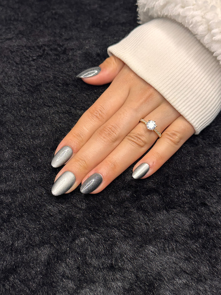 Close-up of Adèle silver glitter almond press on nails