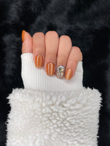 Ambre press on nails — golden amber shimmer finish, hand shot