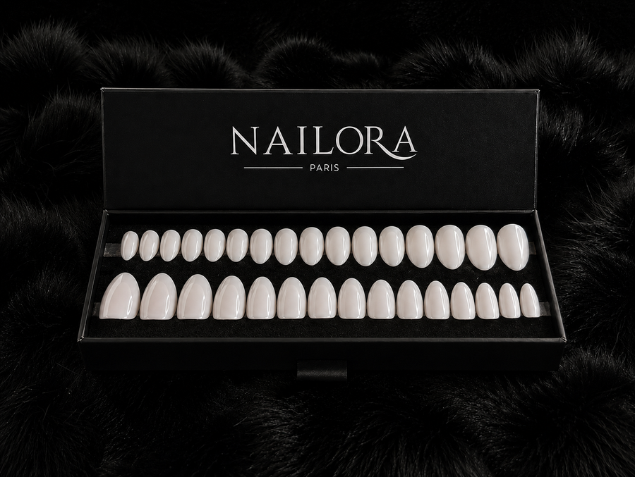 Close-up of Élise white metallic almond press on nails