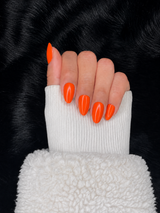 Joséphine neon orange almond press on nails hand pose – Nailora Paris