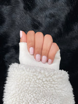 Ivoire milky nude short almond press on nails hand view 2 — Nailora Paris