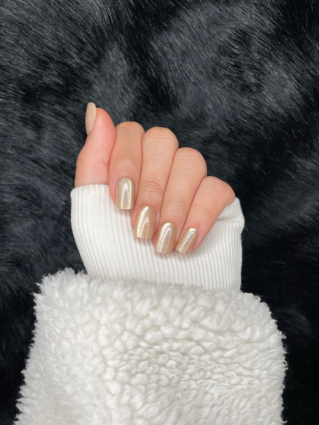 Dorée gold shimmer square nails closed fist view — Nailora Paris