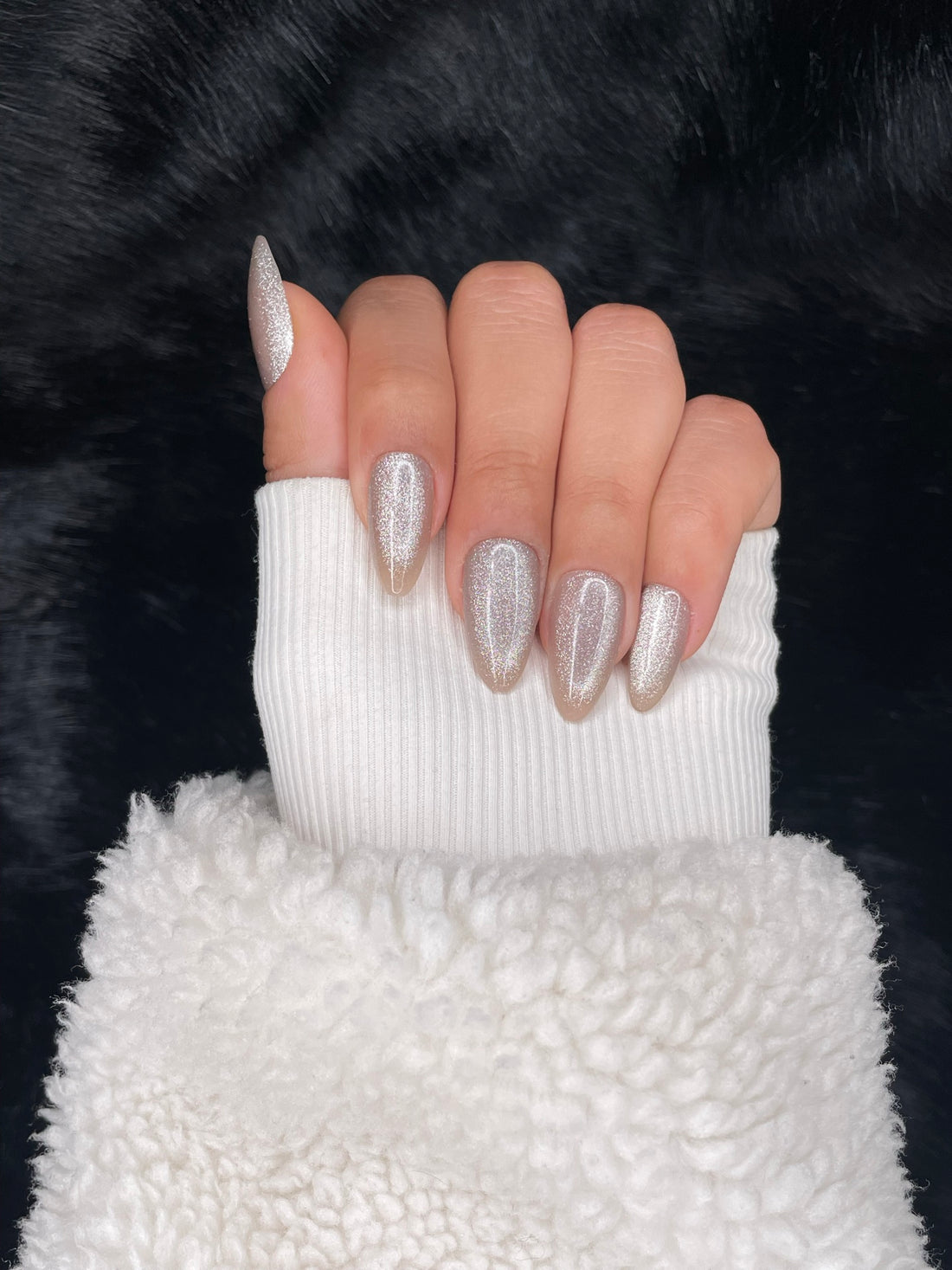 Givré iridescent silver almond nails closed fist view — Nailora Paris