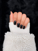 Onyx glossy black square nails closed fist view — Nailora Paris