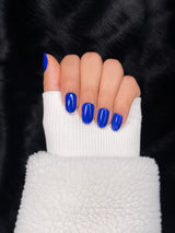 Saphir royal blue almond nails closed fist view — Nailora Paris