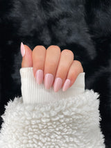 Sophie nude pink almond press on nails hand pose – Nailora Paris