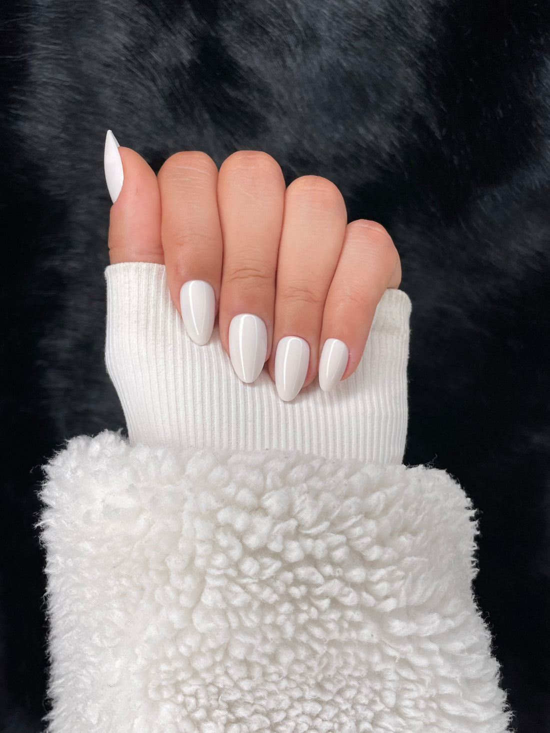 Victoire white almond press on nails hand pose – Nailora Paris